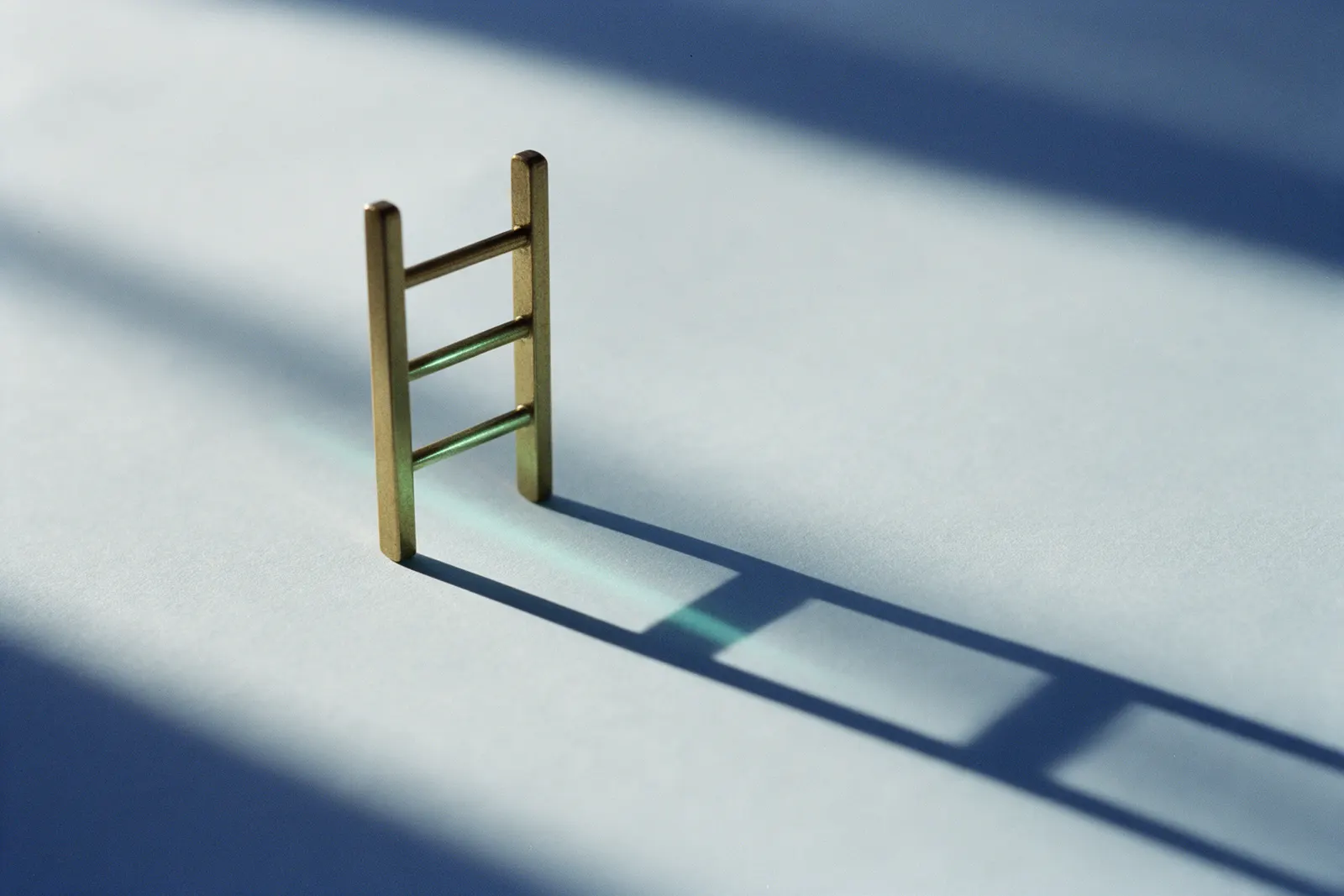 A small brass ladder with three rungs